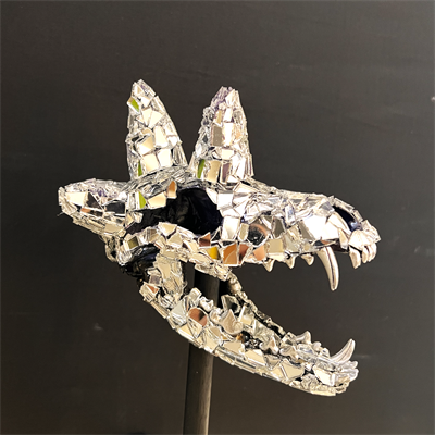 An artistic depiction of a fragmented head of an animal on a stick